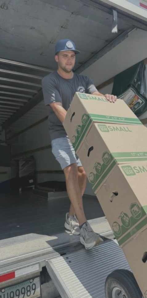 Blake Schambeau moving boxes from a Panhandle Moving truck